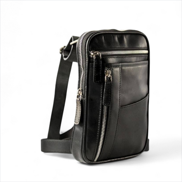 Black leather crossbody bag with zippers on a white background