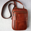 Brown leather crossbody bag on a light gray background