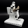 Officially licensed Stormtrooper Pooper Trooper figurine seated on a toilet reading a newspaper right side view
