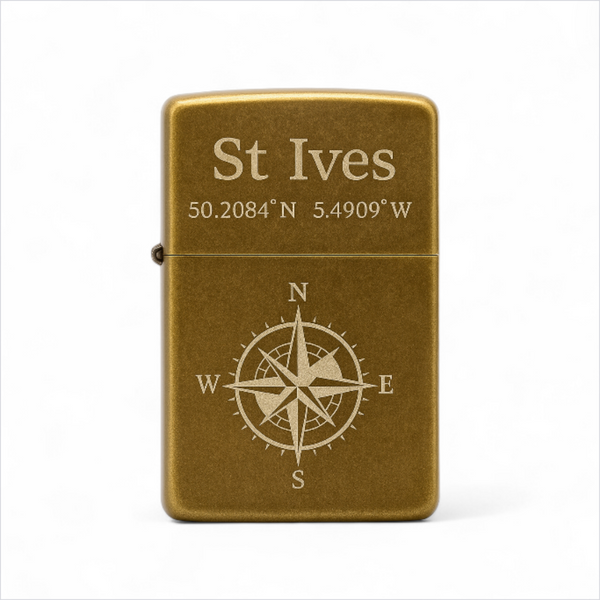 Brass lighter with 'St Ives' and coordinates engraved on a white background