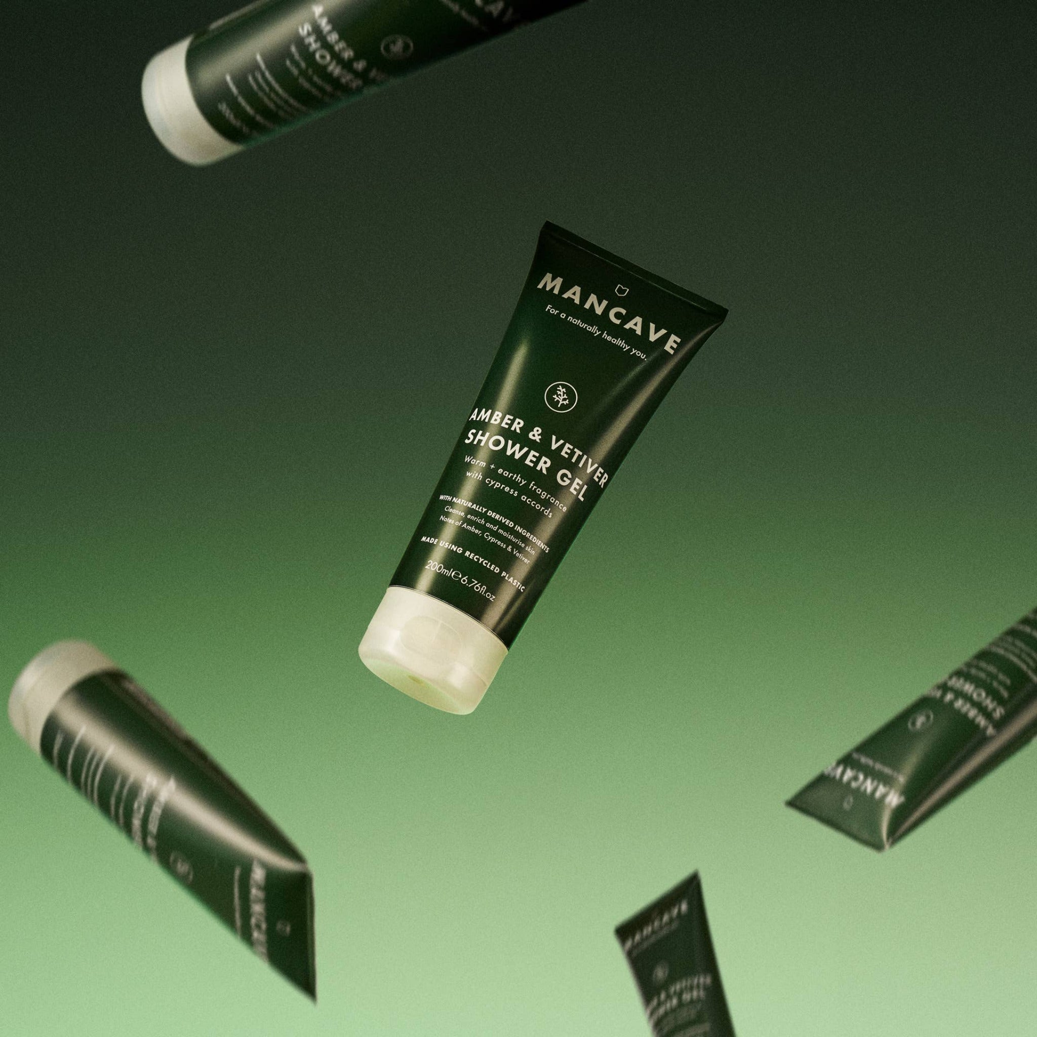 ManCave Amber & Vetiver Shower Gel 200ml floating against a green background.