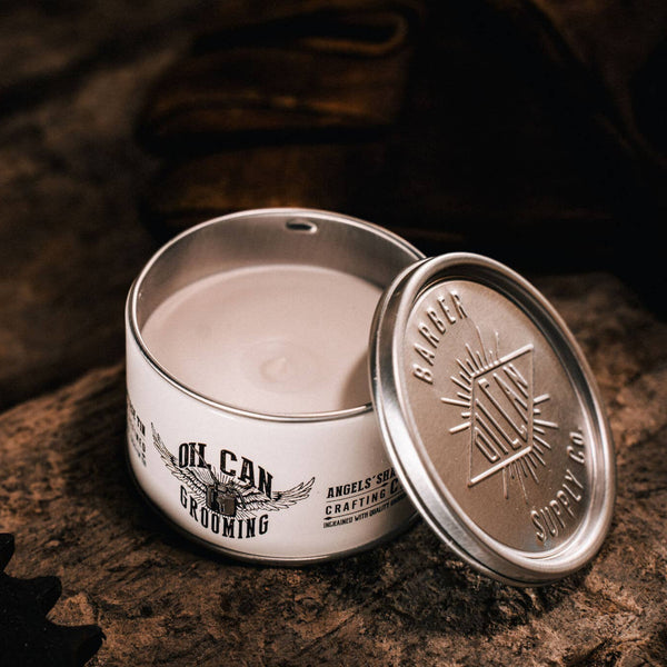 Angel’s Share Crafting Clay open tin on rustic wooden surface with vintage grooming accessories and warm lighting