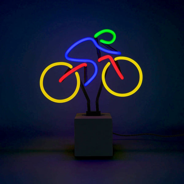 Colourful bicycle neon lamp glowing on a concrete effect base against a dark background