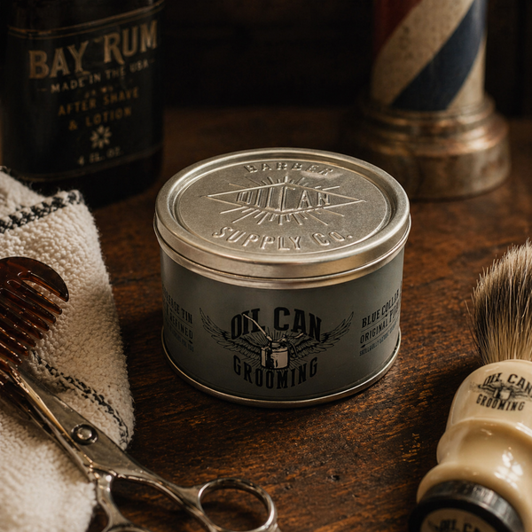 Blue Collar Original Pomade on rustic wooden barbershop counter with grooming tools and shaving accessories