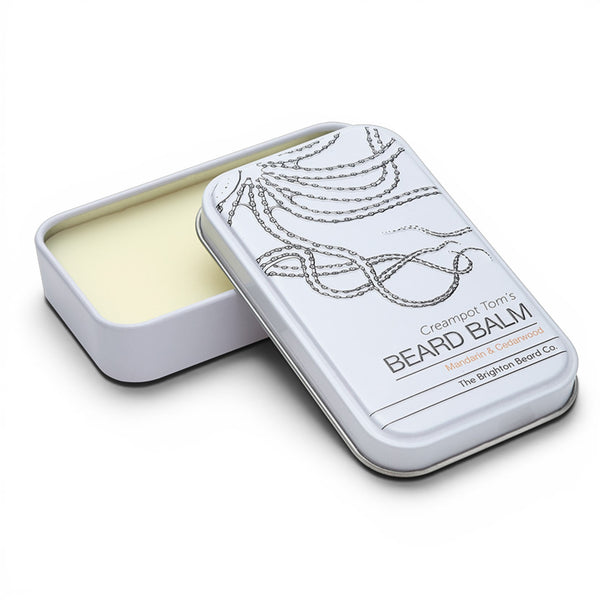 The Brighton Beard Co. Mandarin and Cedarwood Beard Balm presented in a metal tin with lid partially open