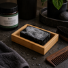 The Brighton Beard Co beard shampoo bar in bamboo tray within moody bathroom lifestyle setting