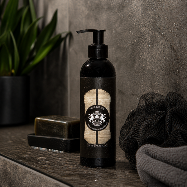 Dear Barber hair and beard conditioner bottle on dark bathroom countertop with towel and soap tray