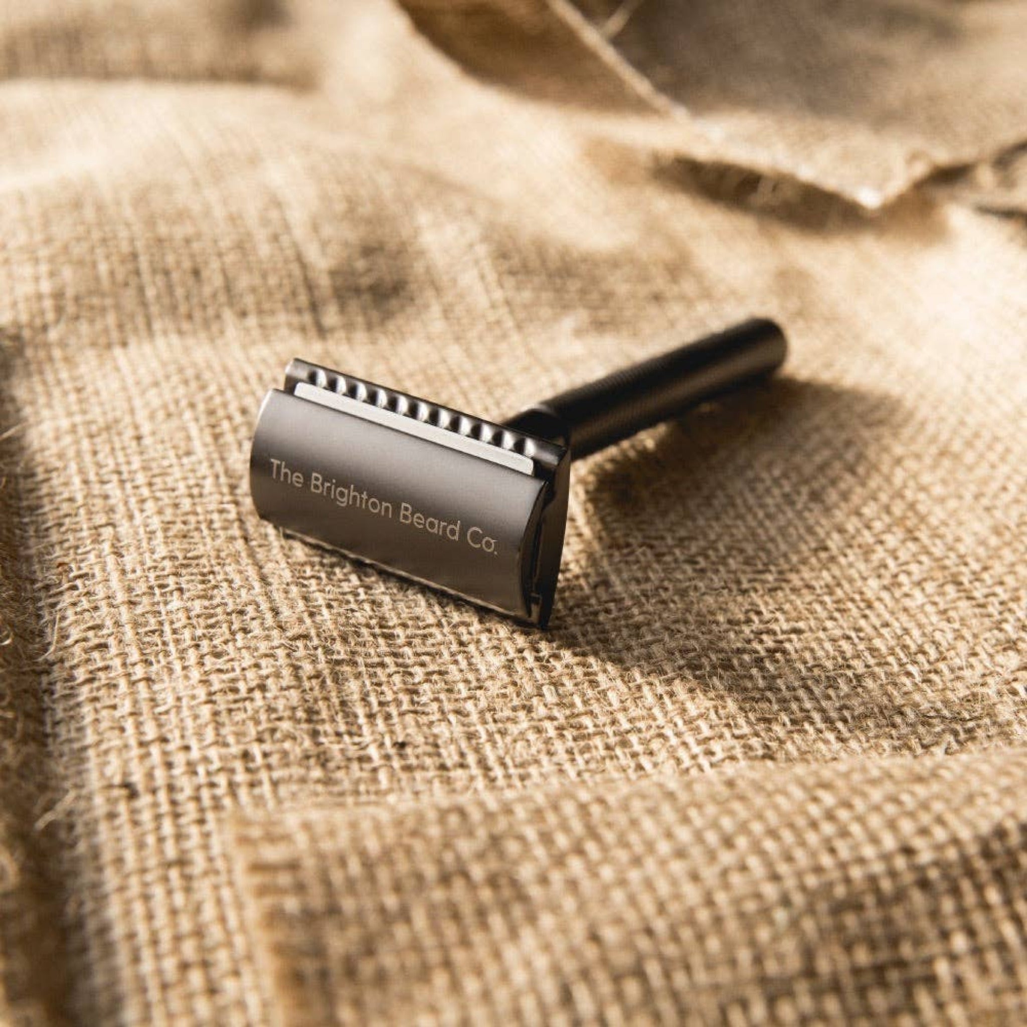 Close up of double edge safety razor with textured metal grip