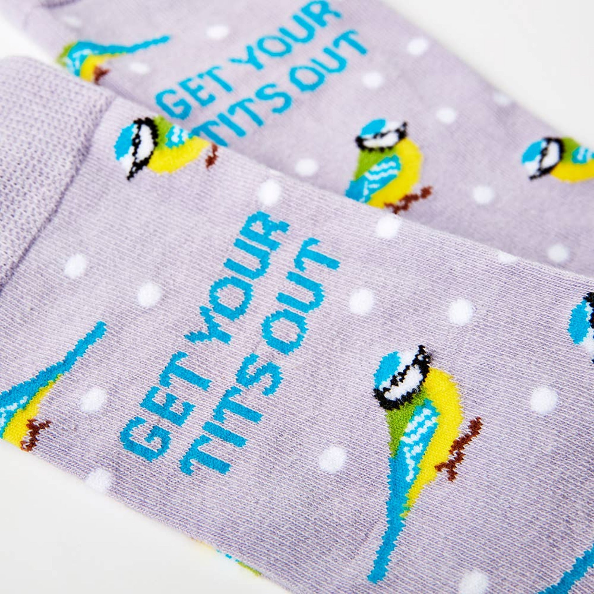 close up of Get Your Tits Out socks showing bird design and text