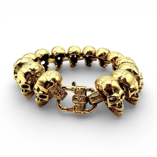 Heavyweight gold skull link bracelet with detailed skull links and trigger clasp