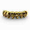 Close up detail of gold skull links on a heavyweight bracelet