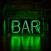 Green BAR neon sign glowing on a wooden surface with dark brick wall background and green light reflections