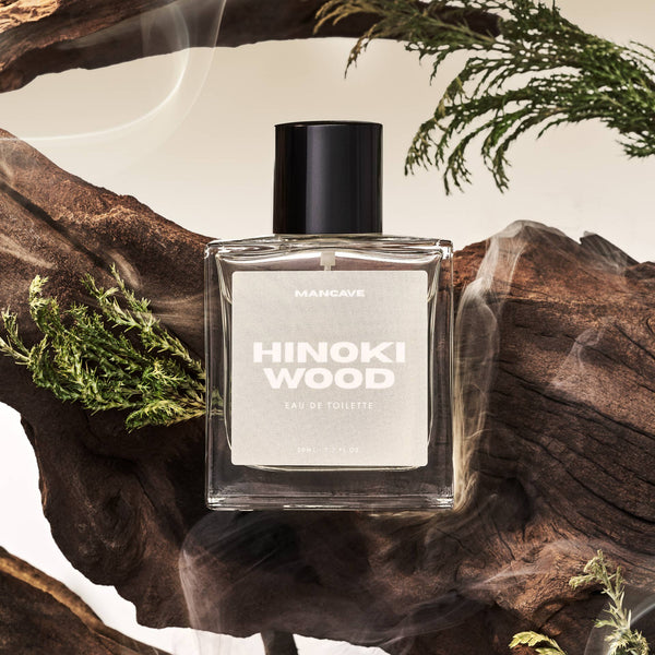 Man Cave Hinoki Eau de Toilette 50ml displayed on natural wood inspired by Japanese hinoki cypress.