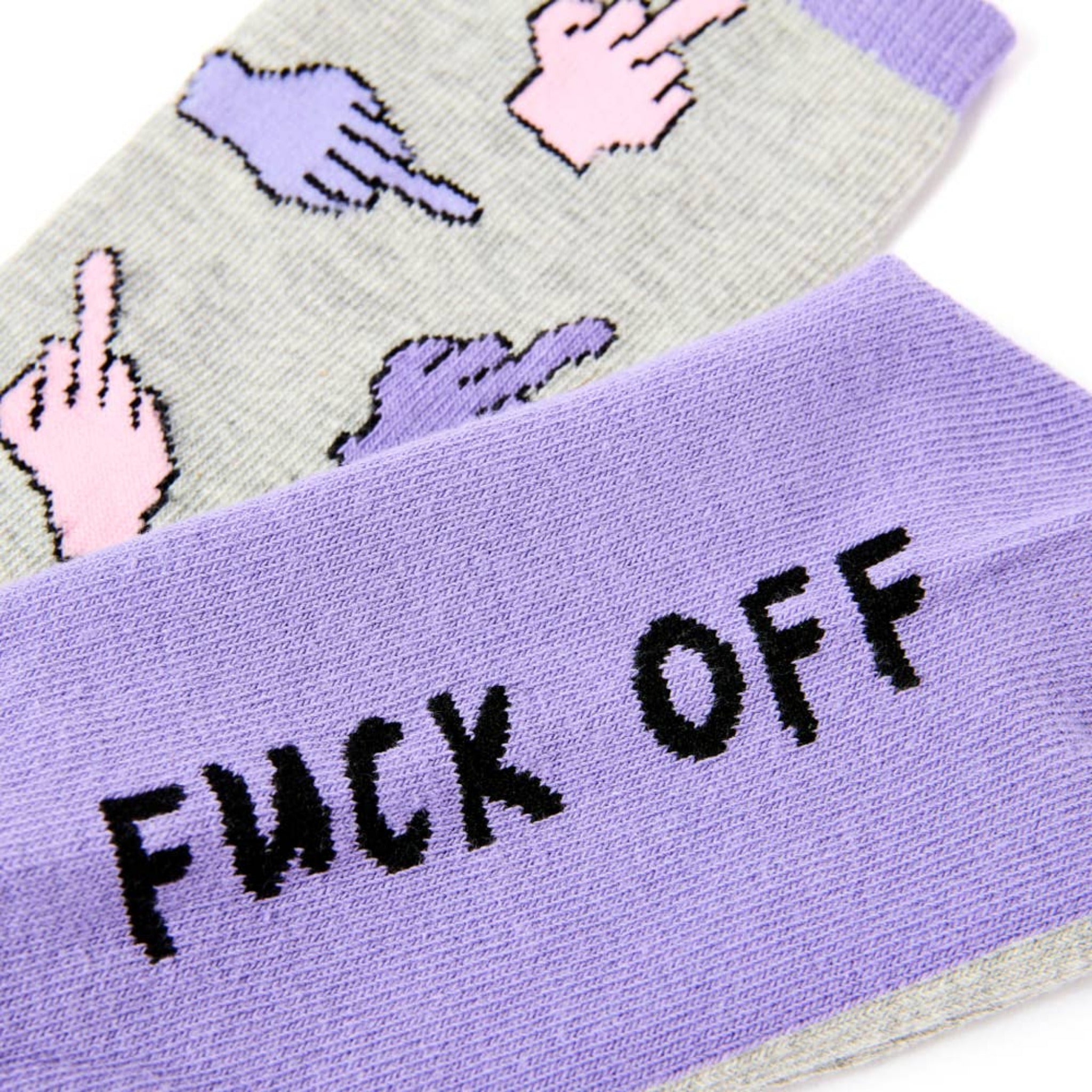 Close up of bold slogan on purple novelty socks with colourful pattern