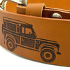 Close up of engraved Land Rover design on brown leather belt showing texture and detail