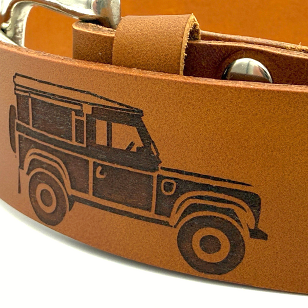 Close up of engraved Land Rover design on brown leather belt showing texture and detail