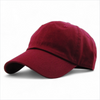 Burgundy low profile cotton baseball cap with curved peak and relaxed fit.