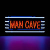 Front view of Man Cave neon sign glowing in blue and red lighting