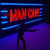Man Cave glass neon sign displayed in a stylish entertainment room setting