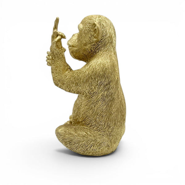 Medium golden resin monkey with middle finger on white background