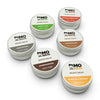 Six Mo Bros beard balm tins from the beard care gift set displayed on a white background