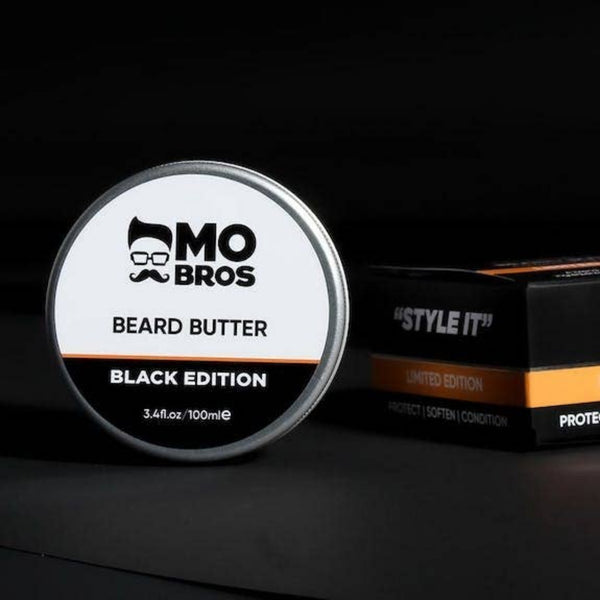 Mo Bros Black Edition Beard Butter in a dark masculine lifestyle scene with product packaging
