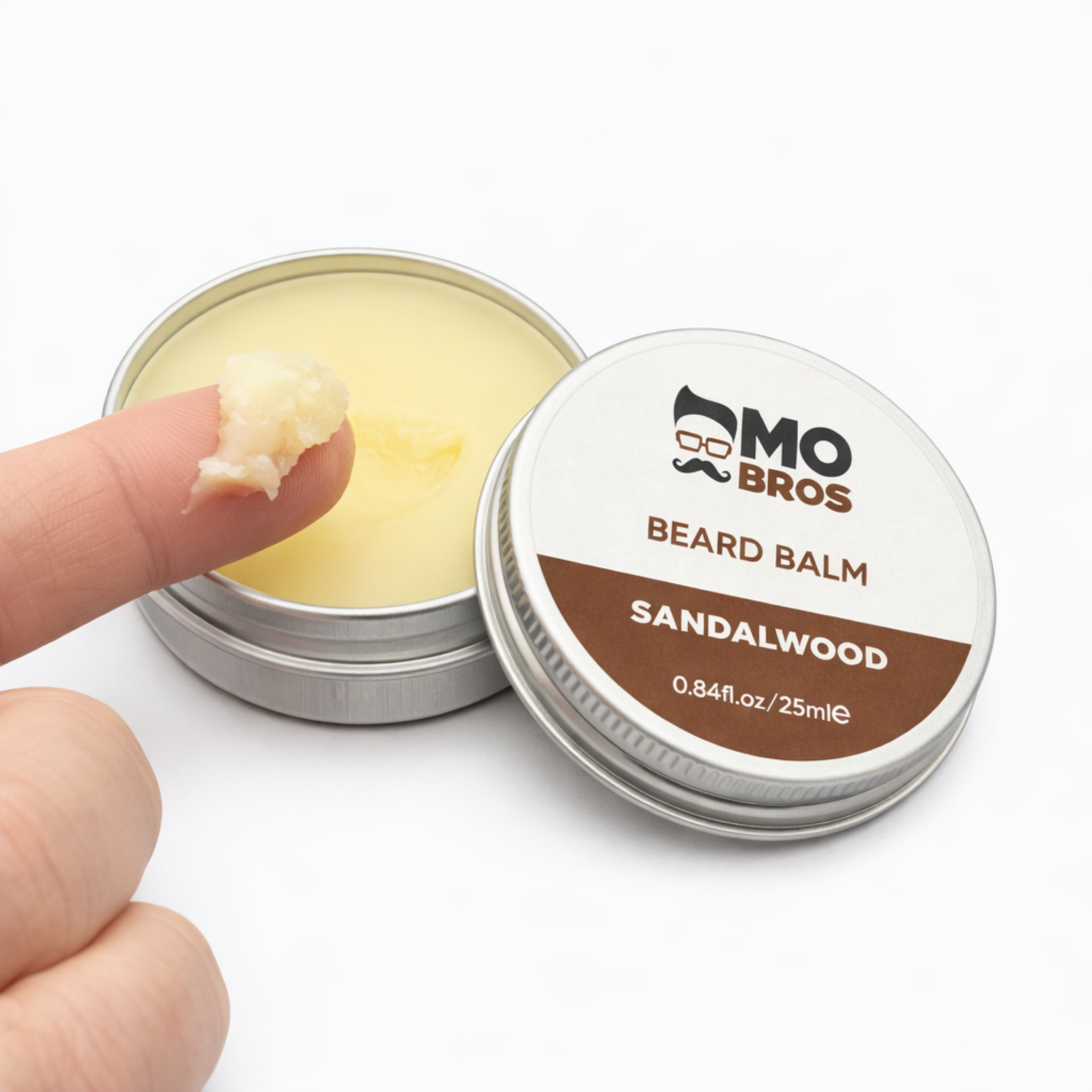Applying Mo Bros Sandalwood Beard Balm 25ml with fingertip