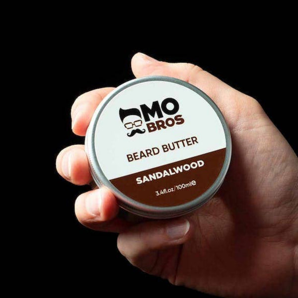 Mo Bros Sandalwood Beard Butter held in hand lifestyle image