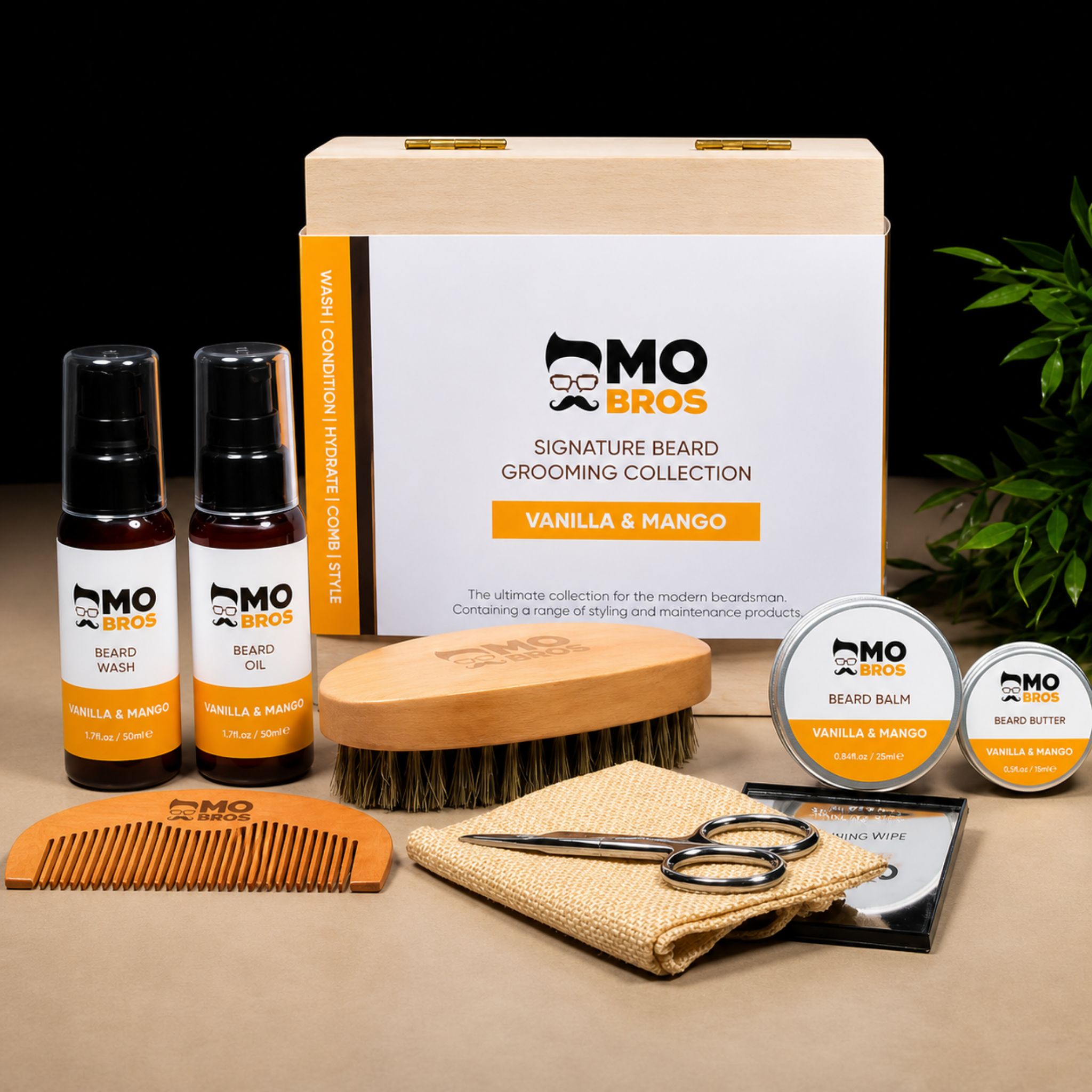 Mo Bros vanilla and mango signature beard grooming collection with grooming products and wooden presentation box styled on warm neutral background