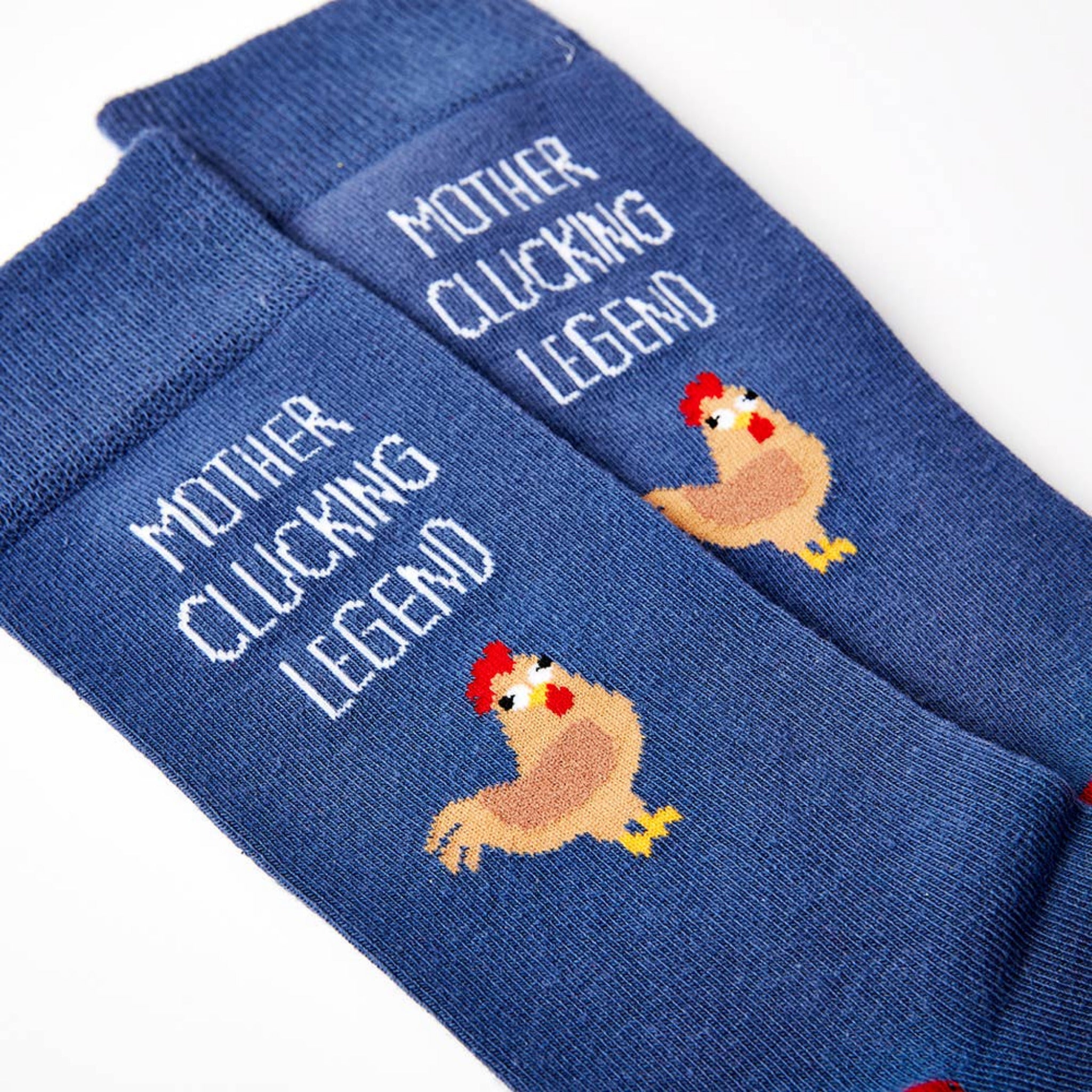 close up of Mother Clucking Legend socks showing chicken design and text