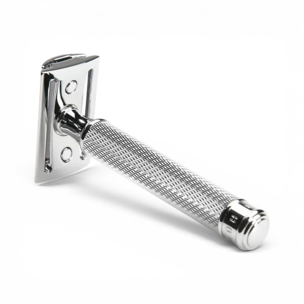 Angled view of MÜHLE R89 chrome safety razor showing textured handle and closed comb head