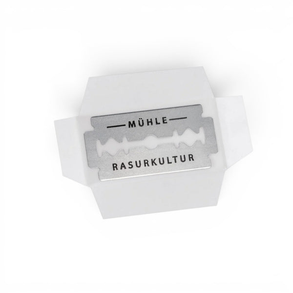 Single MÜHLE stainless steel double edge razor blade on white background