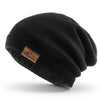 Black oversized slouch beanie with sherpa fleece lining and relaxed fit styling.