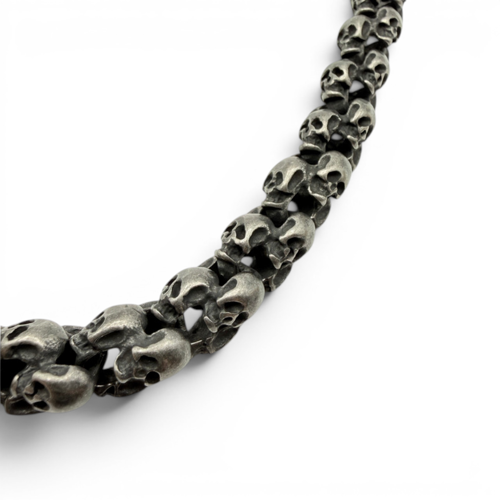 Close up detail of oxidised skull link necklace showing interlocking skull design
Oxidised skull necklace arranged in natural shape showing thickness and finish