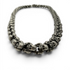 Oxidised skull necklace arranged in natural shape showing thickness and finish