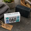 Paper Plane Emergency Dad Soap with charcoal soap bar and towel on dark stone surface