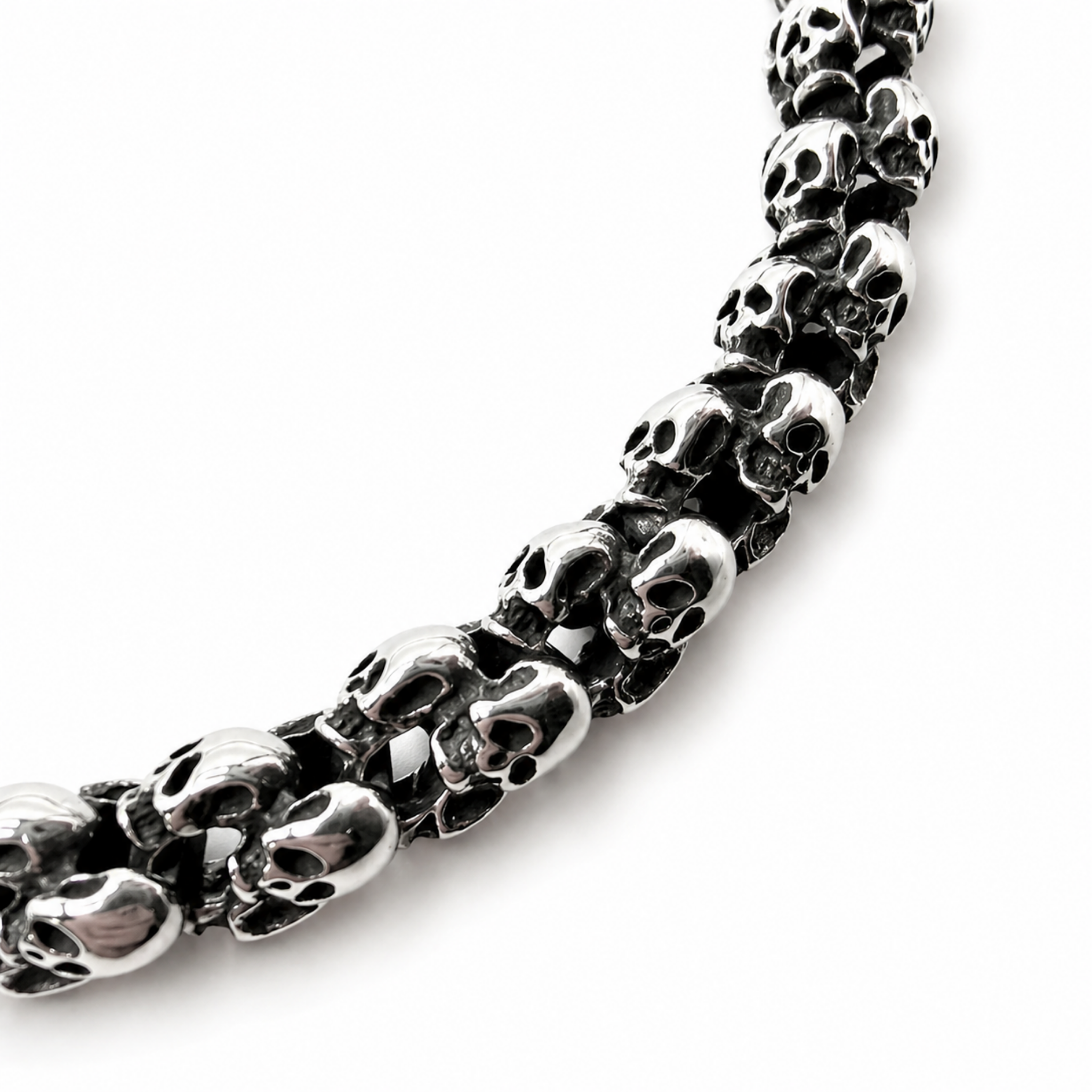 Close up of polished stainless steel skull links with dark detailing