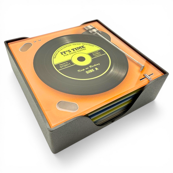 Set of six record player design glass coasters stacked in a black holder on a white background, shown at an angle with vinyl and tonearm detail visible