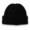 Black ribbed knit beanie with folded cuff on a white background with soft natural shadow.