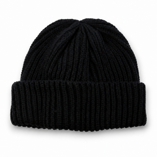 Black ribbed knit beanie with folded cuff on a white background with soft natural shadow.