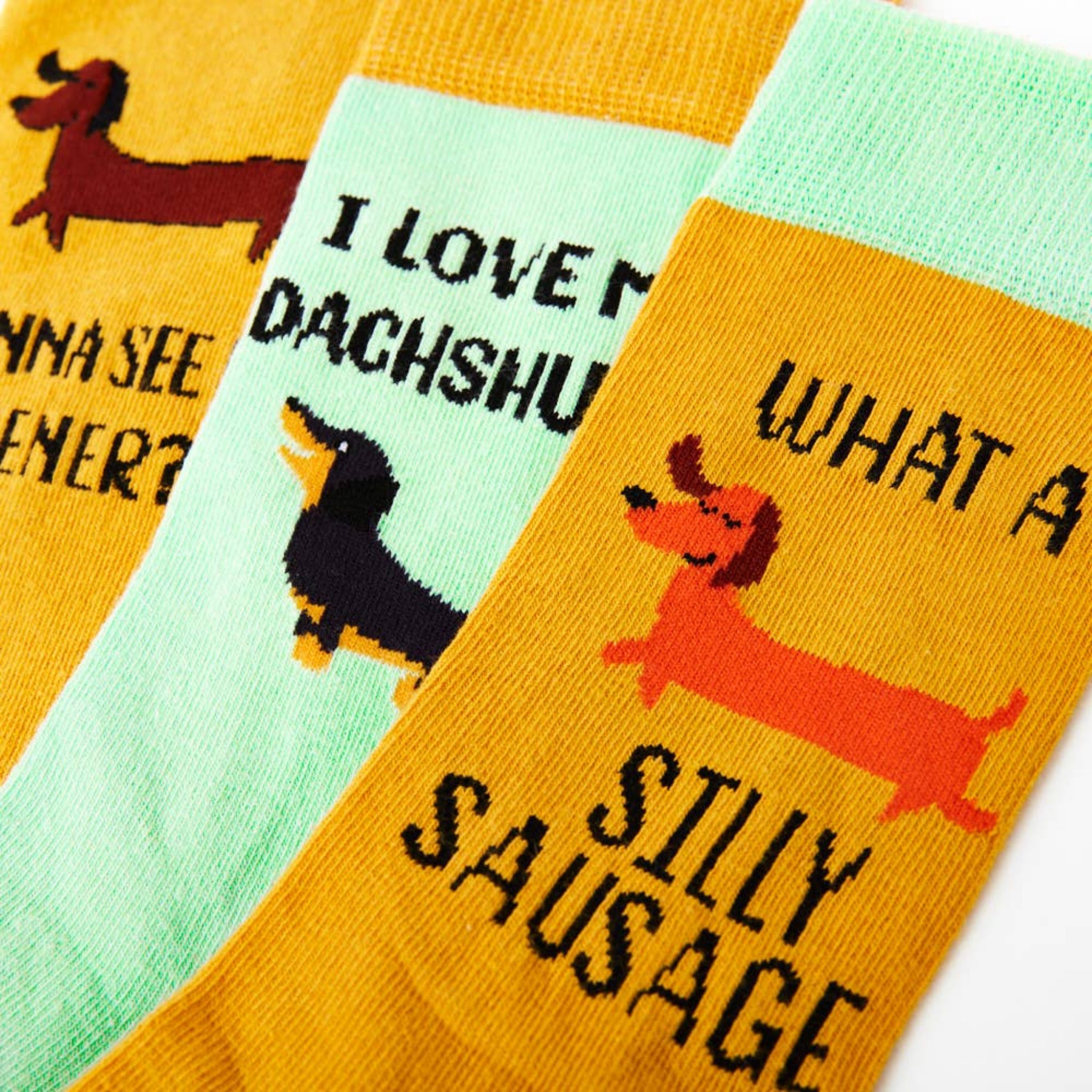 close up of sausage dog socks showing novelty text and dachshund designs