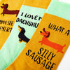 close up of sausage dog socks showing novelty text and dachshund designs
