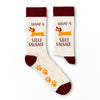 Pair of novelty socks showing silly sausage slogan and dog graphic