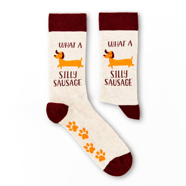 Pair of novelty socks showing silly sausage slogan and dog graphic