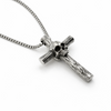 Stainless steel skull cross necklace with 3mm box chain on a clean white background with soft shadow, angled view highlighting depth and texture of the cross and skull design