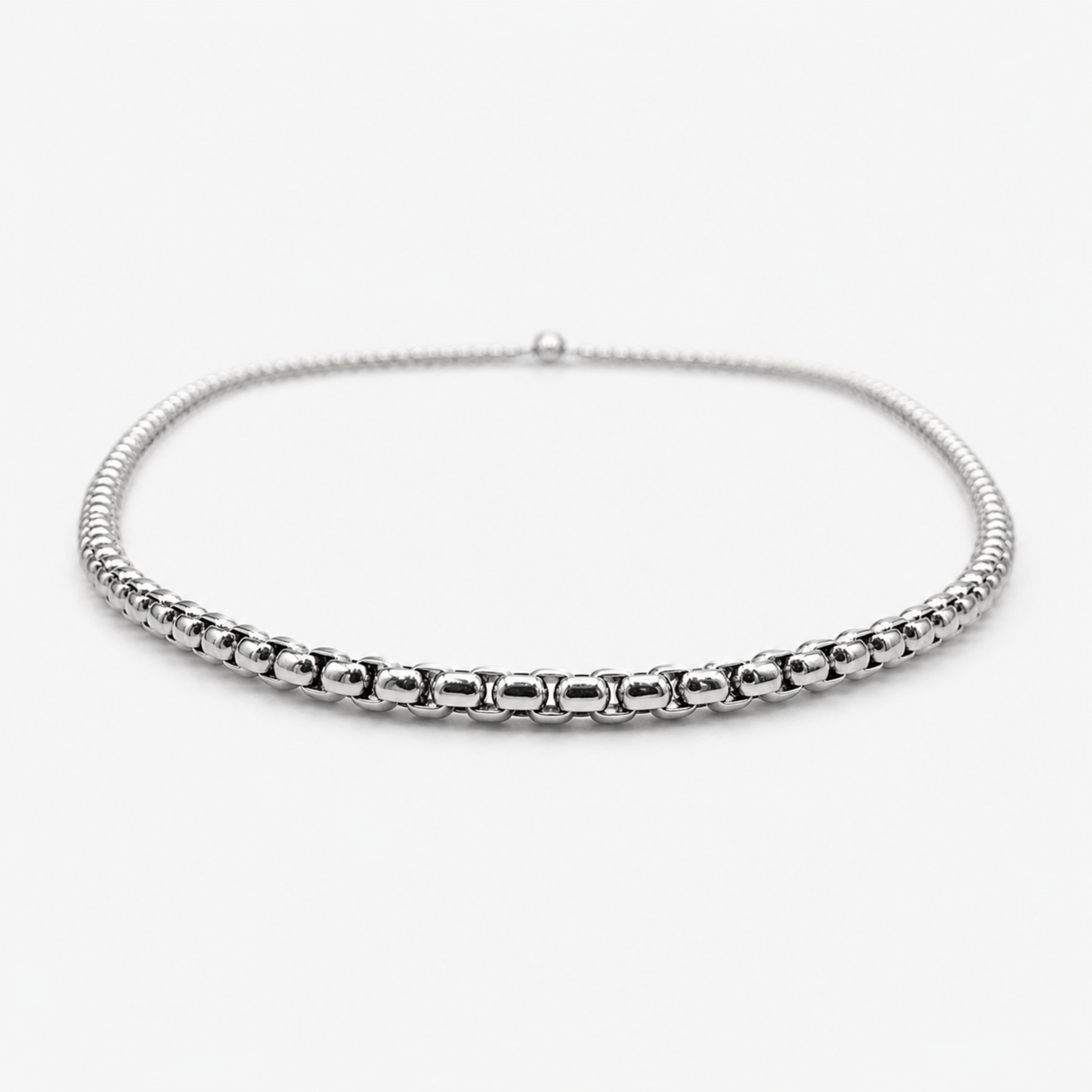 Low angle view of stainless steel 2mm rounded box chain necklace showing thickness and profile