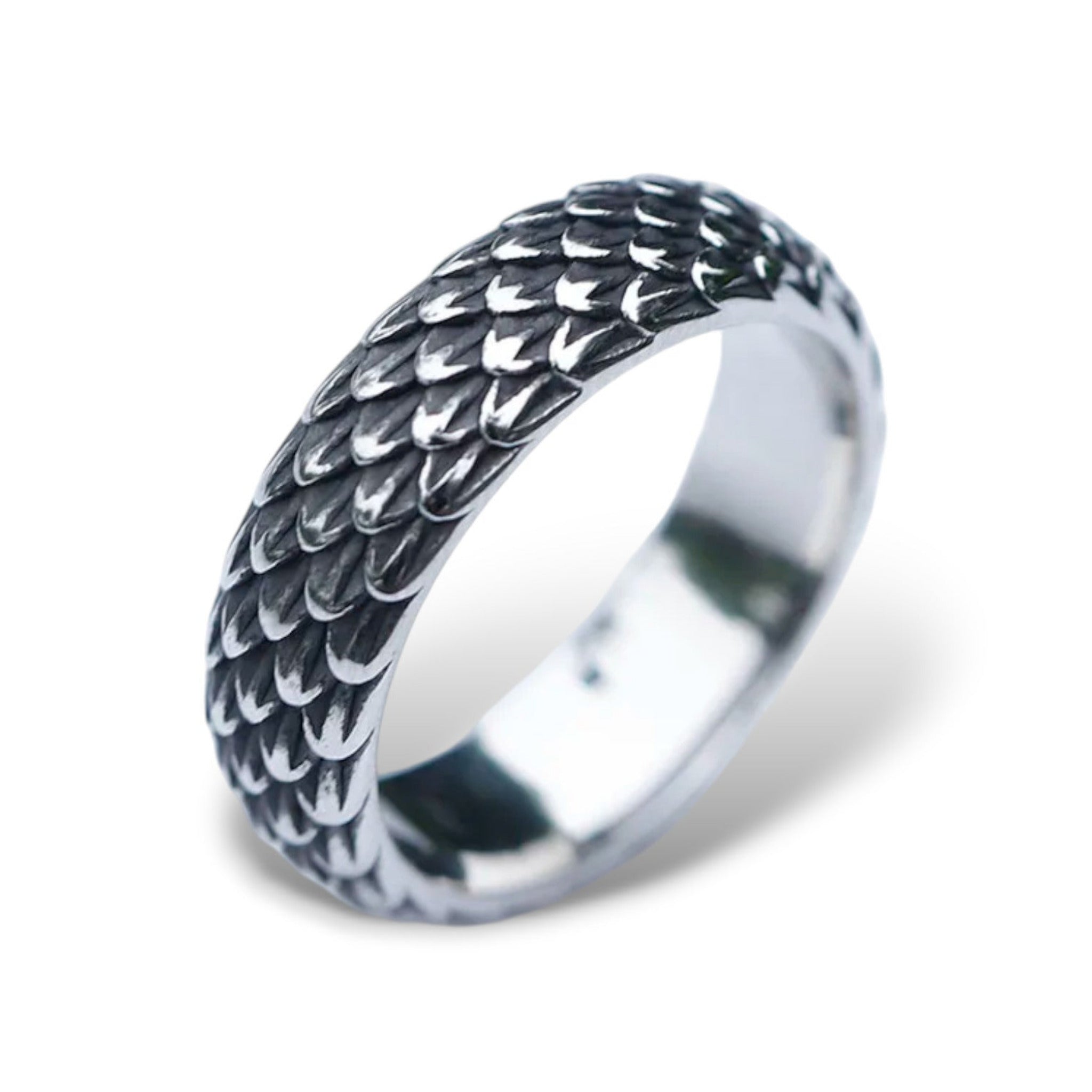 A stainless steel ring with a detailed, textured dragon scale design.
