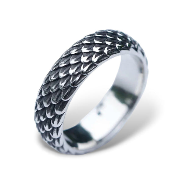 A stainless steel ring with a detailed, textured dragon scale design.