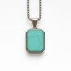Stainless steel pendant with turquoise stone inlay on 20 inch box chain white background