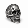 Front view of a stainless steel skull ring with a detailed vintage finish on a white background.